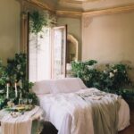 interior of a bedroom with lots of plants and decorated in a vintage luxurious style